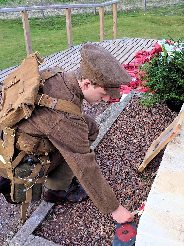 Gloucestershire College Student dressed in WW1 Uniform, laying a cross at the Lochnagar Memorial