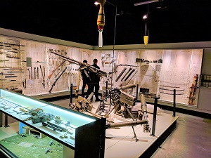 Photo inside the museum showing a display of various weaponry