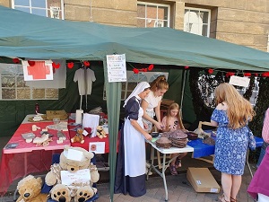 Photo of Lynn Page and Zoe Allan supervising children's activities in thw WW1 Field Hospital