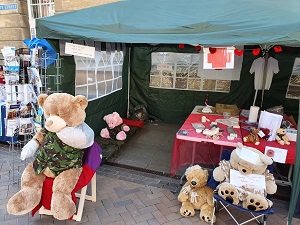 Photo of Tommy the Teddy and his teddy bear friends in the WW1 Field Hospital